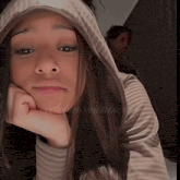 a woman wearing a hooded sweatshirt with the words celebmomentsss on the bottom right