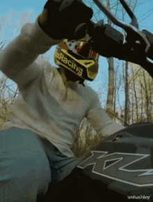 a man wearing a helmet that says racing