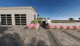 a rendering of a house with a driveway and flowers