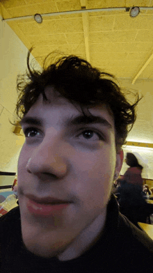 a close up of a young man 's face with a blurred background