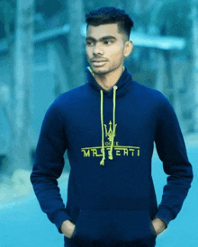 a man wearing a blue sweatshirt that says maserati on it