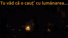 a man holding a lit candle in the dark with the words tu vad ca o caut cu luminarea below him