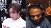a man and a woman are sitting next to each other in front of a sign that says station n.