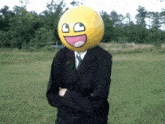 a man wearing a suit and tie has a smiley face on his head