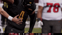 a football player wearing a number 4 jersey