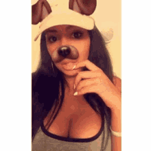 a woman wearing a dog mask and a hat with a dog nose .