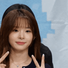 a girl giving a peace sign with her hands