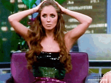 a woman is sitting in a purple chair with her hands on her head and the words anahioverdose on the bottom right
