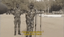 a man in a military uniform is standing in front of a microphone and talking about anarco-syndicalism .