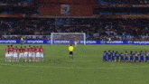 a group of soccer players on a field with hyundai advertisements