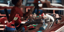 a person playing a video game with a toy crab