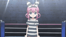 a girl with pink hair is standing in a boxing ring with tokyo mx on the bottom right