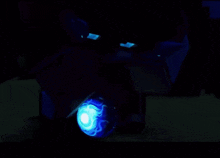 a dark room with a blue light in the middle of the room