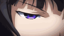 a close up of a person 's eye with a purple iris