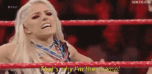 a woman is sitting in a wrestling ring and says `` that 's why i 'm the champ ! ''