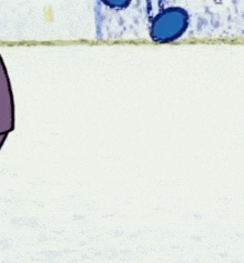 a blue cartoon character is smiling and jumping in the air while standing on a snowy field .
