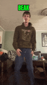 a man wearing a hoodie that says nirvana is standing in a living room