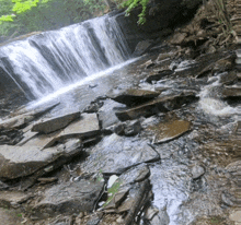 a waterfall in the middle of a rocky area