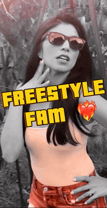 a woman wearing sunglasses stands in front of a sign that says freestyle fam on it