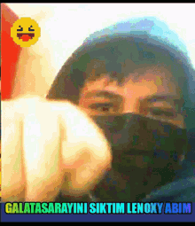 a man wearing a black mask is pointing at the camera with the words galatasarayini siktim lenoxy abim below him