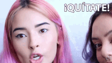 two women with pink hair are standing next to each other with the words iquitate written on the top