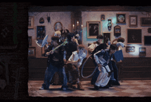 a group of people are standing in front of a wall with pictures on it