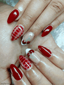 a close up of a woman 's nails with a cherry design
