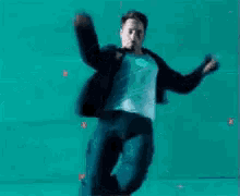 a man in a suit is sitting on the floor making a face .