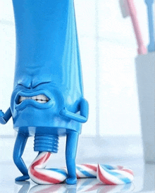 a blue tube of toothpaste with arms and legs holding a candy cane