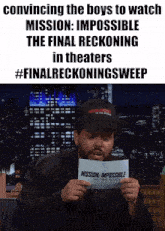 a man is holding a piece of paper that says mission impossible the final reckoning in theaters
