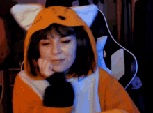a woman in a fox costume is sitting in a gaming chair