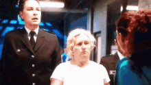 a woman in a white shirt is talking to a man in a black suit