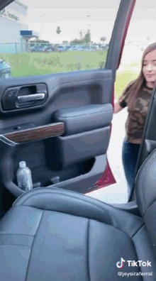 a tiktok video of a woman getting out of a car
