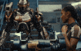 a woman standing next to a robot with the word kepler on the bottom right