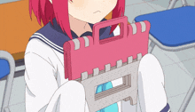 a girl with red hair is holding a pink clipboard with the letter f on it