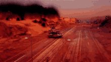a tank is driving down a highway with smoke coming out of the mountains in the background
