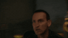 a close up of a man 's face with a purple eye