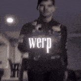 a man is holding a sign that says " werp "