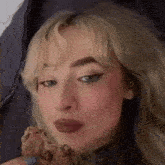 a close up of a woman eating a piece of bread .