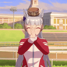 a girl in a red and white jacket is covering her mouth with her hands