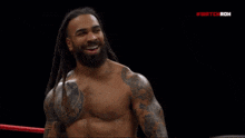 a man with dreadlocks is in a boxing ring with the word ring on the bottom