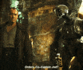 a man and a robot are standing next to each other and the robot says orders ca-captain jod?