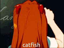 a girl with red hair is writing on a blackboard and the word catfish is above her head