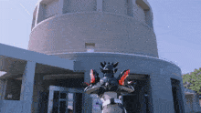 a man in a robot costume stands in front of a building that has the word theatre on it