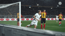 a soccer player wearing a number 6 jersey is running towards the goal