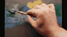 a hand is holding a spatula and painting on a canvas with the words made in animatica below it