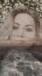 a double exposure of a woman 's face in the water with birds flying around her .