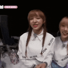 a girl wearing a white sweater that says wjsn