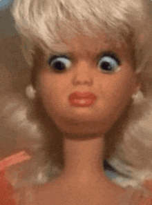 a close up of a barbie doll making a surprised face