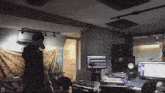 a man stands in a recording studio with the letter d in the corner